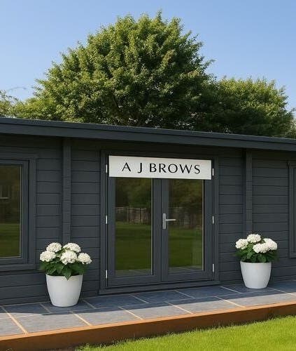 Charming exterior of A J BROWS - SURREY, nestled in Godalming, England, GB among lush greenery.