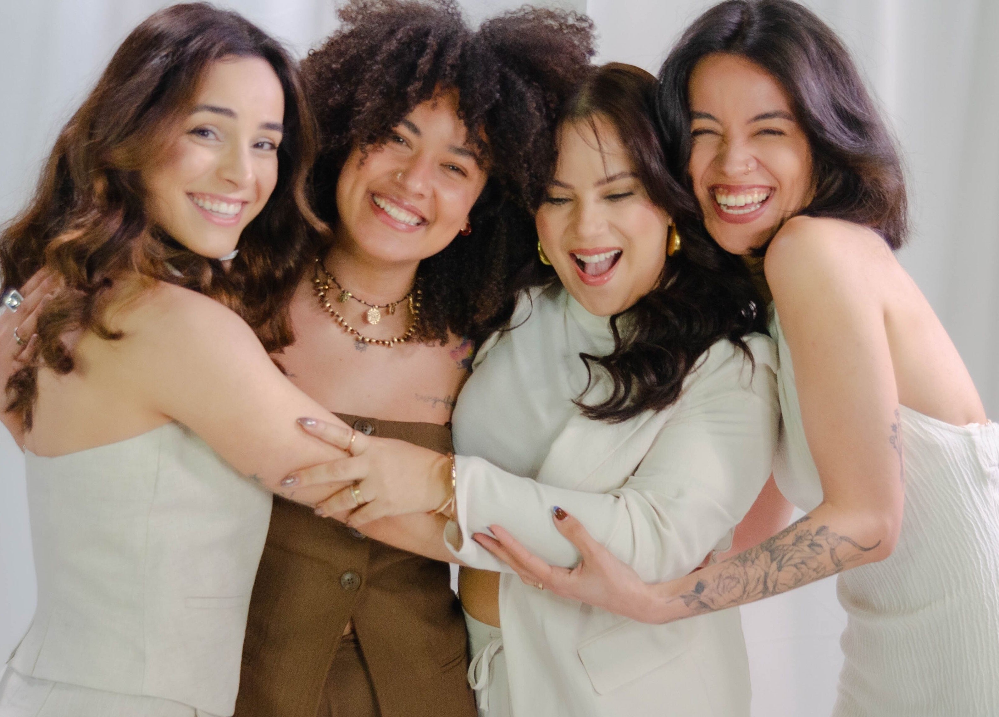 Happy group of women embracing at Bea Brow Artistry, Dublin Southside, County Dublin, IE.