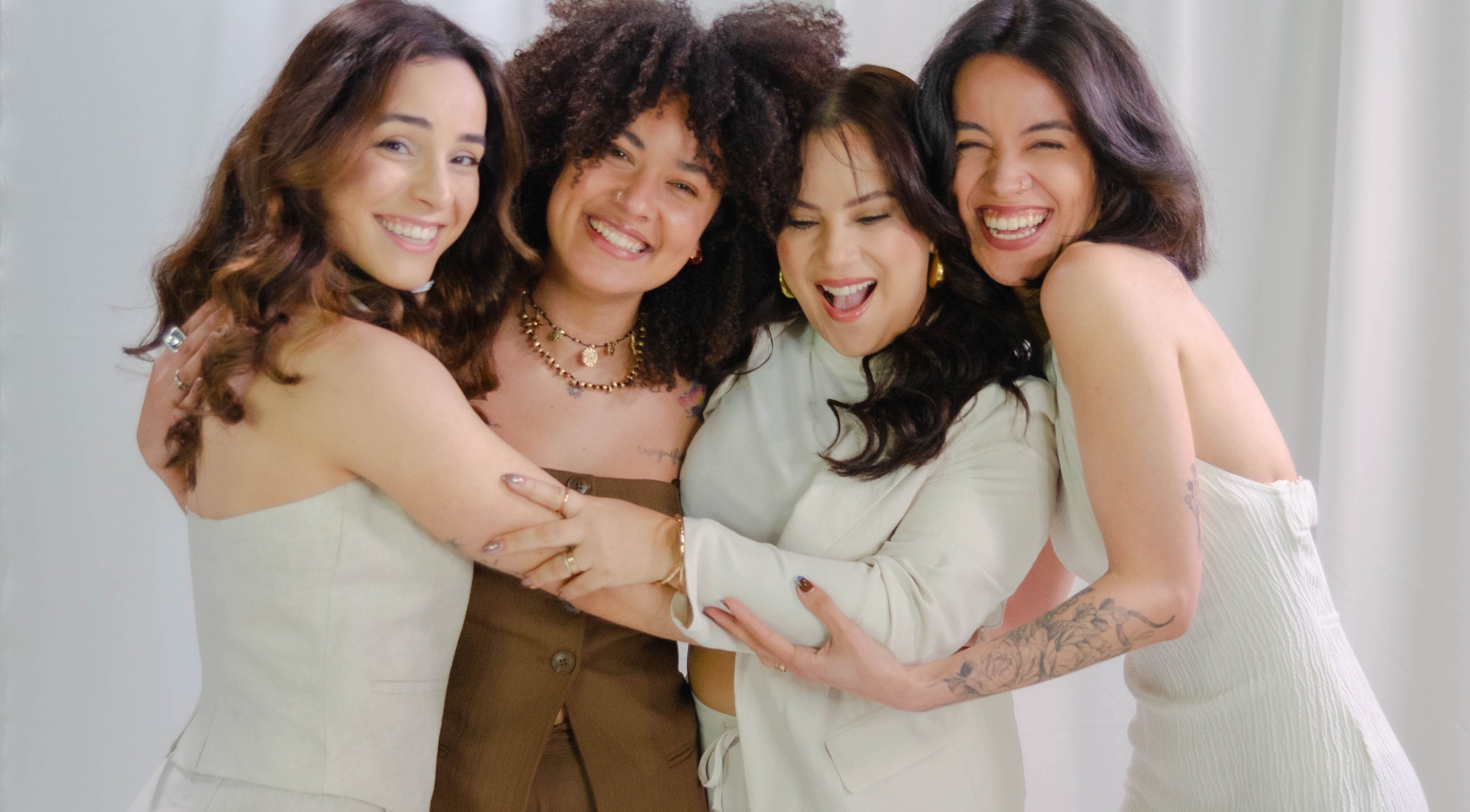 Happy group of women embracing at Bea Brow Artistry, Dublin Southside, County Dublin, IE.