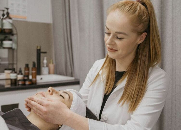 Therapist performing a relaxing facial at Dermaesthetique, Bondi Junction, New South Wales, AU.