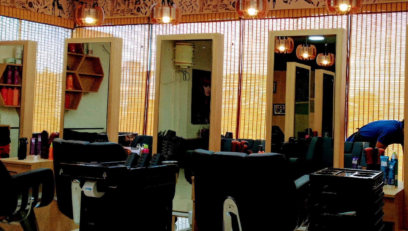 Stylish interior of Tropicurl Salon in Bengaluru, Karnataka, IN, showcasing modern mirrors and salon chairs.