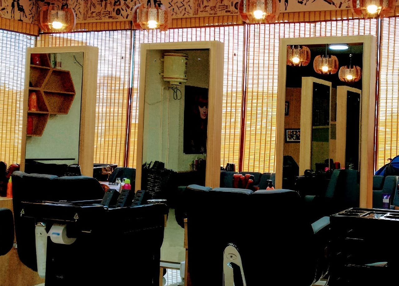 Stylish interior of Tropicurl Salon in Bengaluru, Karnataka, IN, showcasing modern mirrors and salon chairs.