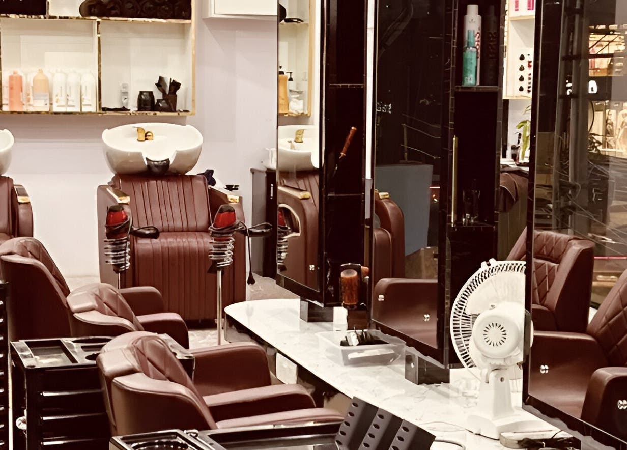 Interior of Tropicurl Salon showcasing plush chairs and mirrors in Bengaluru, Karnataka, IN.
