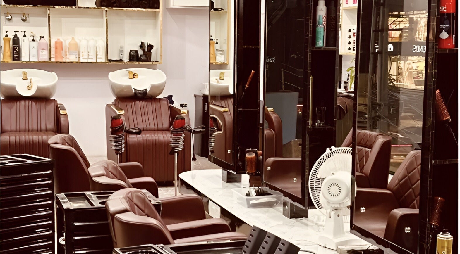 Interior of Tropicurl Salon showcasing plush chairs and mirrors in Bengaluru, Karnataka, IN.