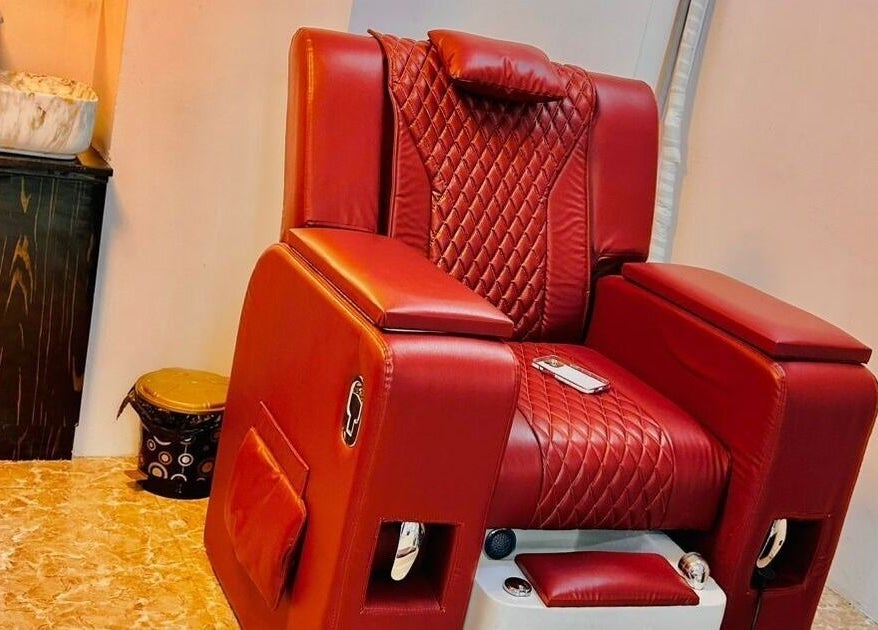 Plush red salon chair at Tropicurl Salon in Bengaluru, Karnataka, IN, offering luxury and comfort.