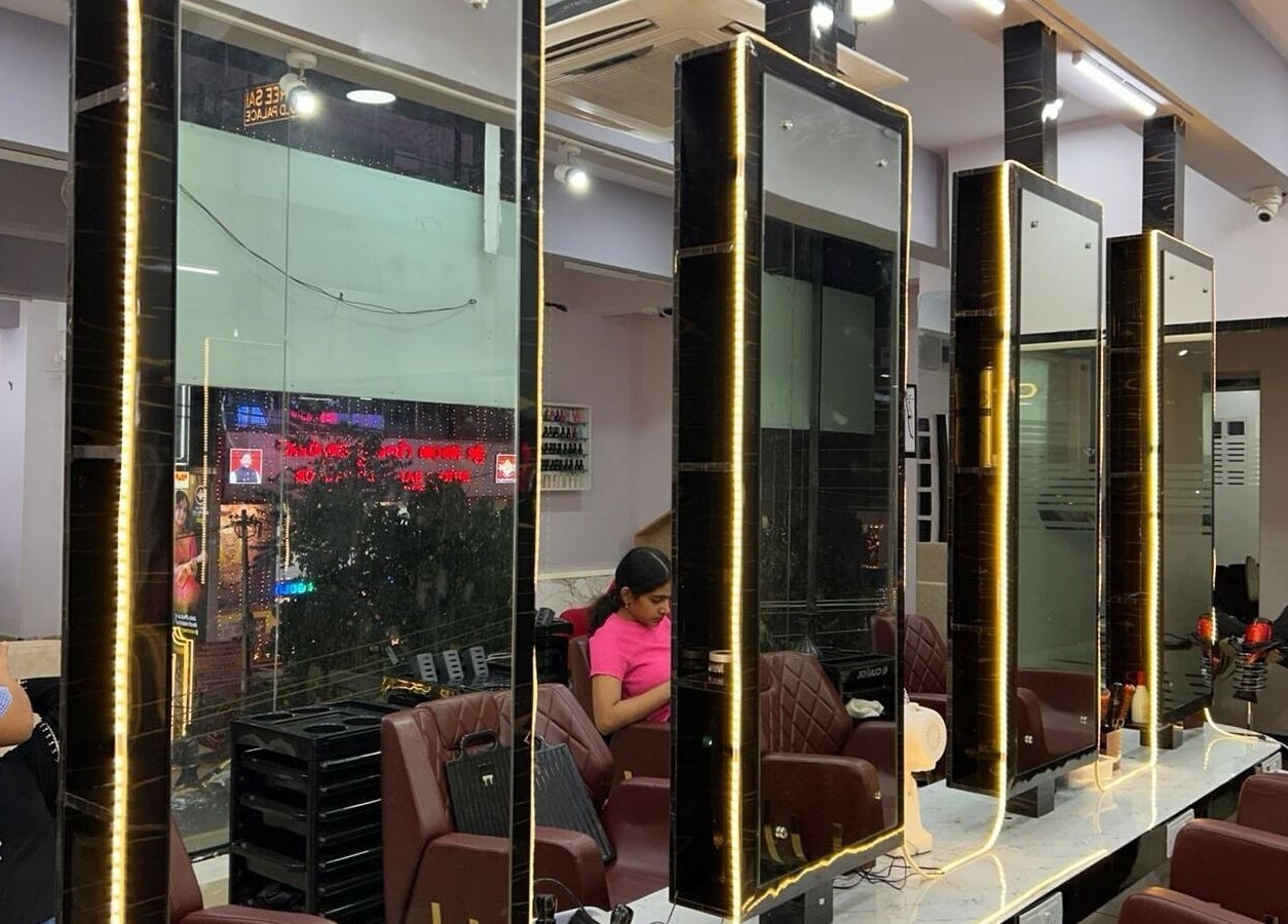 Elegant interior with illuminated mirrors at Tropicurl Salon, Bengaluru, Karnataka, IN.
