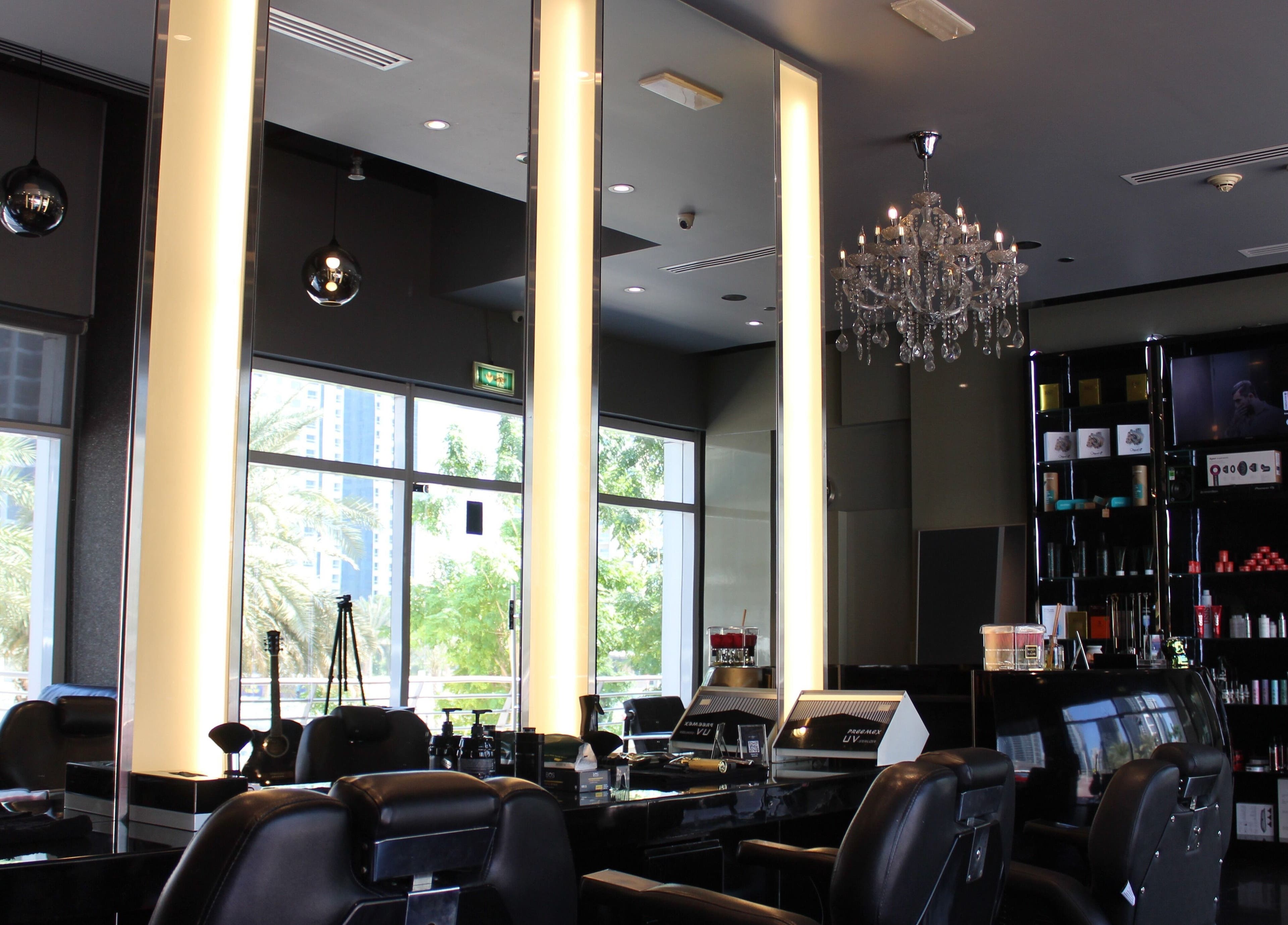 Luxurious interior of The Gentlemen's Lounge, Dubai, AE with elegant furnishings and chandelier.