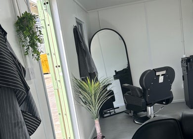 Modern salon interior at Container Cuts - Wilcox House, Cardiff, Wales, GB with sleek decor and a barber chair.