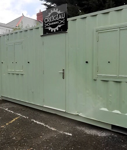 Container Cuts - Wilcox House, Cardiff, Wales, GB: Unique green container salon exterior view.
