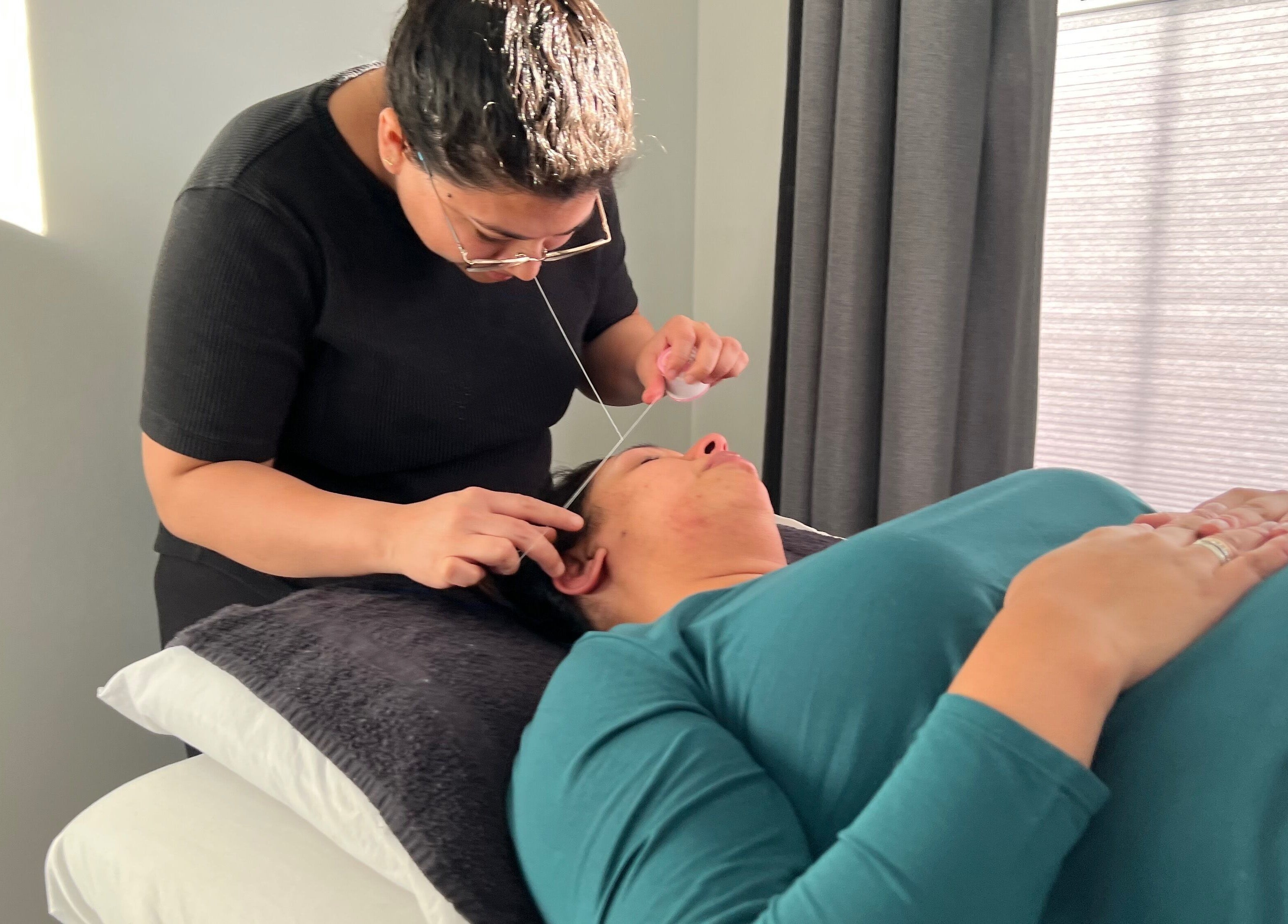 Bala Esthetics Inc. expert performs threading in Edmonton, Alberta, CA for precise eyebrow shaping.