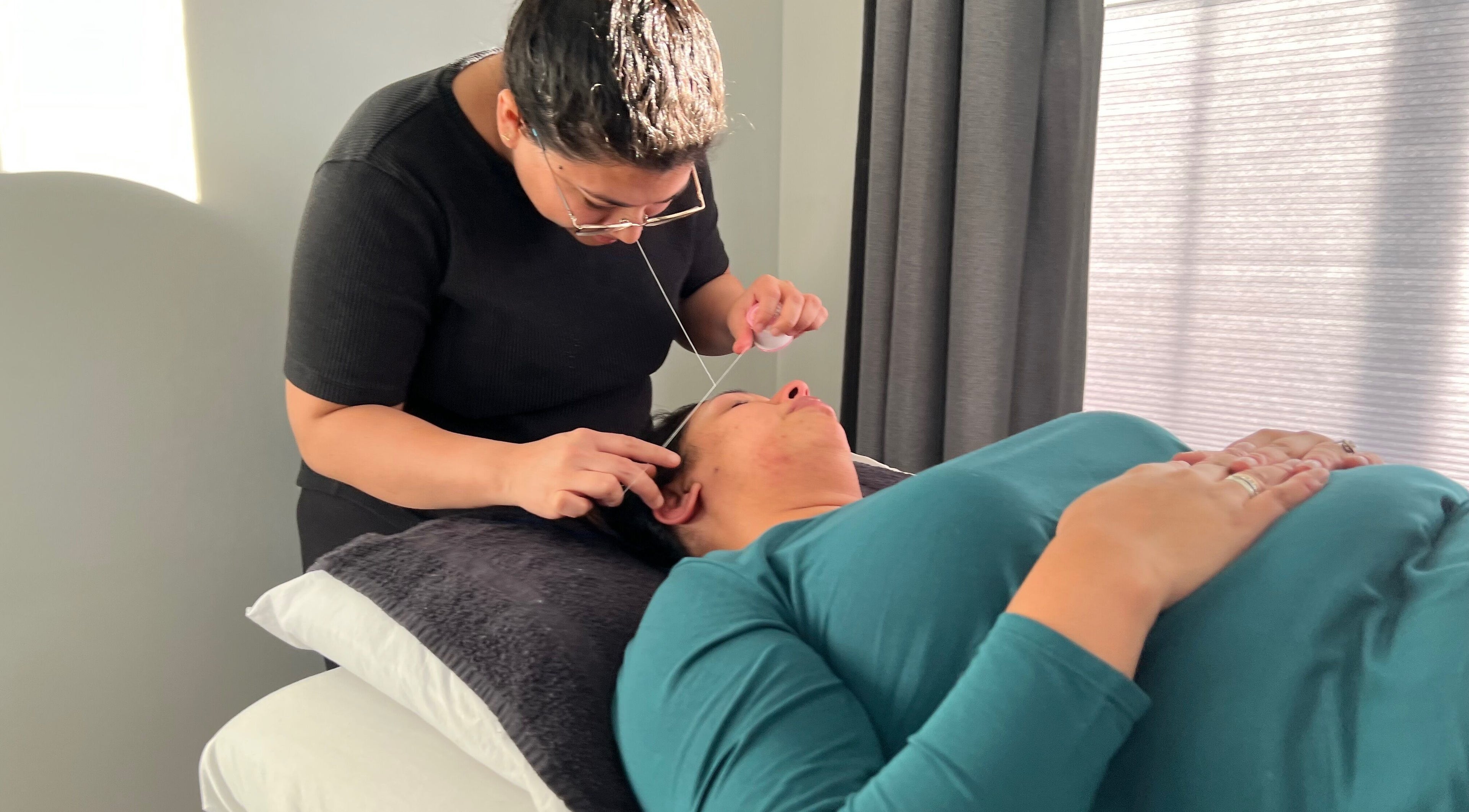 Bala Esthetics Inc. expert performs threading in Edmonton, Alberta, CA for precise eyebrow shaping.