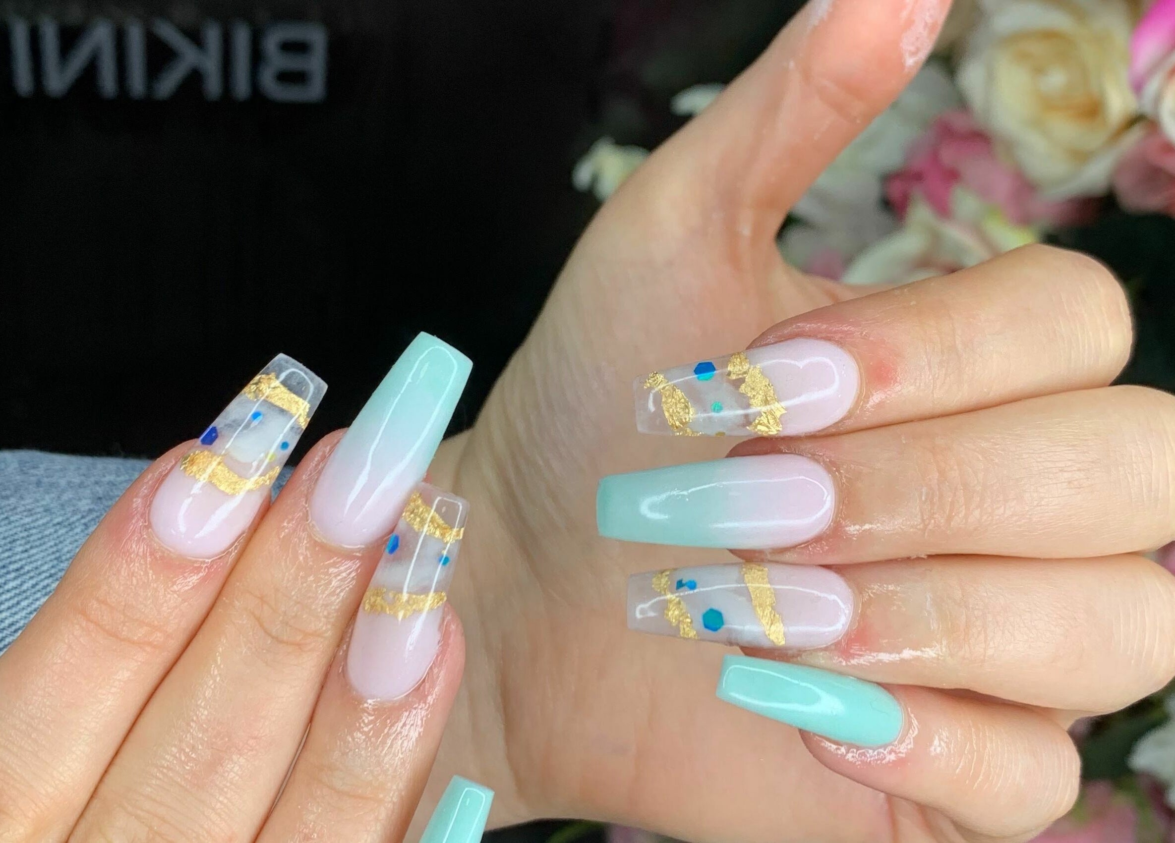 Elegant nail art design at Sudan Angel, London, England, GB, featuring blue and gold accents.