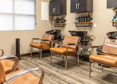 Modern salon chairs in washing area at Its Personal the Salon, Pearland, Texas, US.