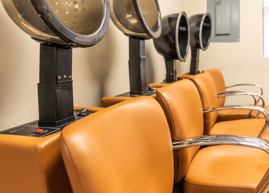 Warm-toned drying chairs at Its Personal the Salon, Pearland, Texas, US, offering a cozy styling experience.