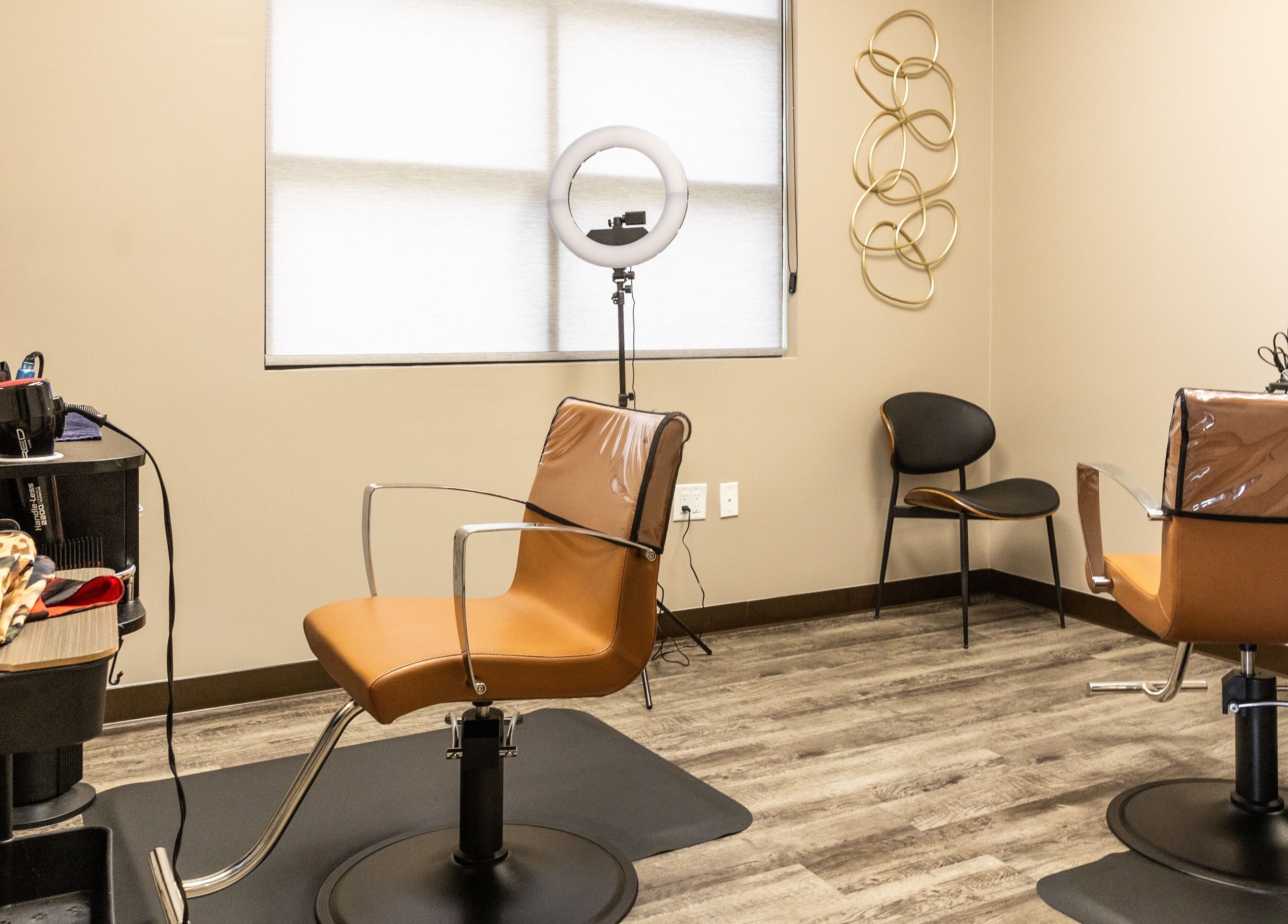 Modern salon interior at Its Personal the Salon in Pearland, Texas, US featuring stylish chairs and a ring light.