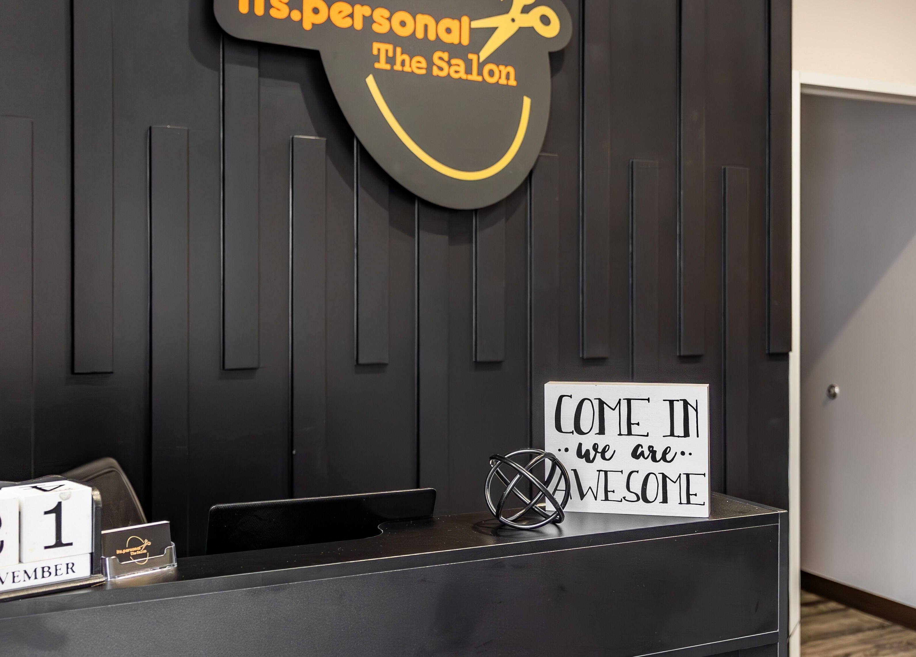 Reception desk at Its Personal the Salon in Pearland, Texas, US with welcoming sign.