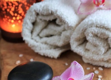 Relaxing spa scene with towels and candles at InsideOut - Body Therapy, Edenvale, Gauteng, ZA.
