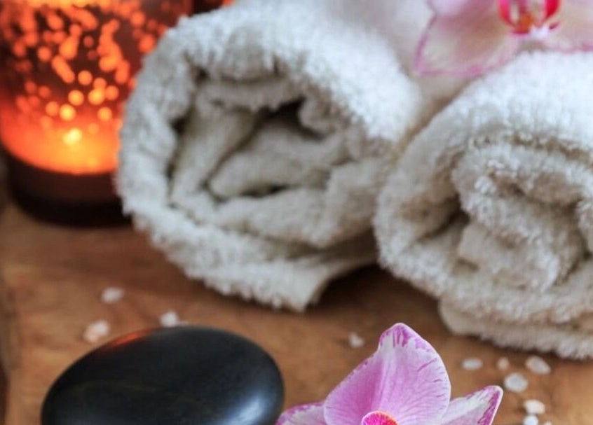 Relaxing spa scene with towels and candles at InsideOut - Body Therapy, Edenvale, Gauteng, ZA.