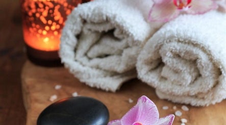 Relaxing spa scene with towels and candles at InsideOut - Body Therapy, Edenvale, Gauteng, ZA.