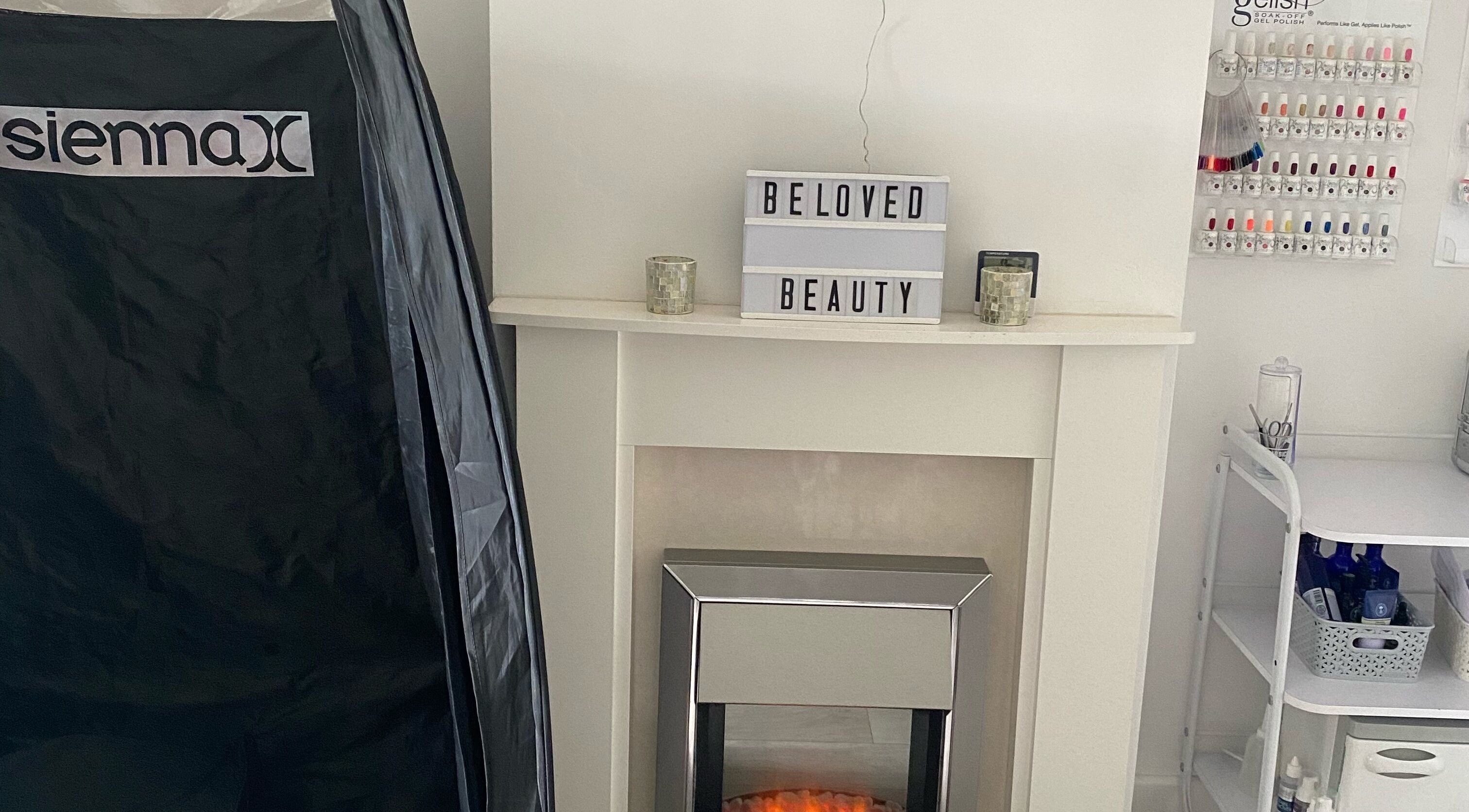 Inviting corner at Beloved Beauty Duxford, featuring a sleek electric fireplace. Located in Duxford, England, GB.