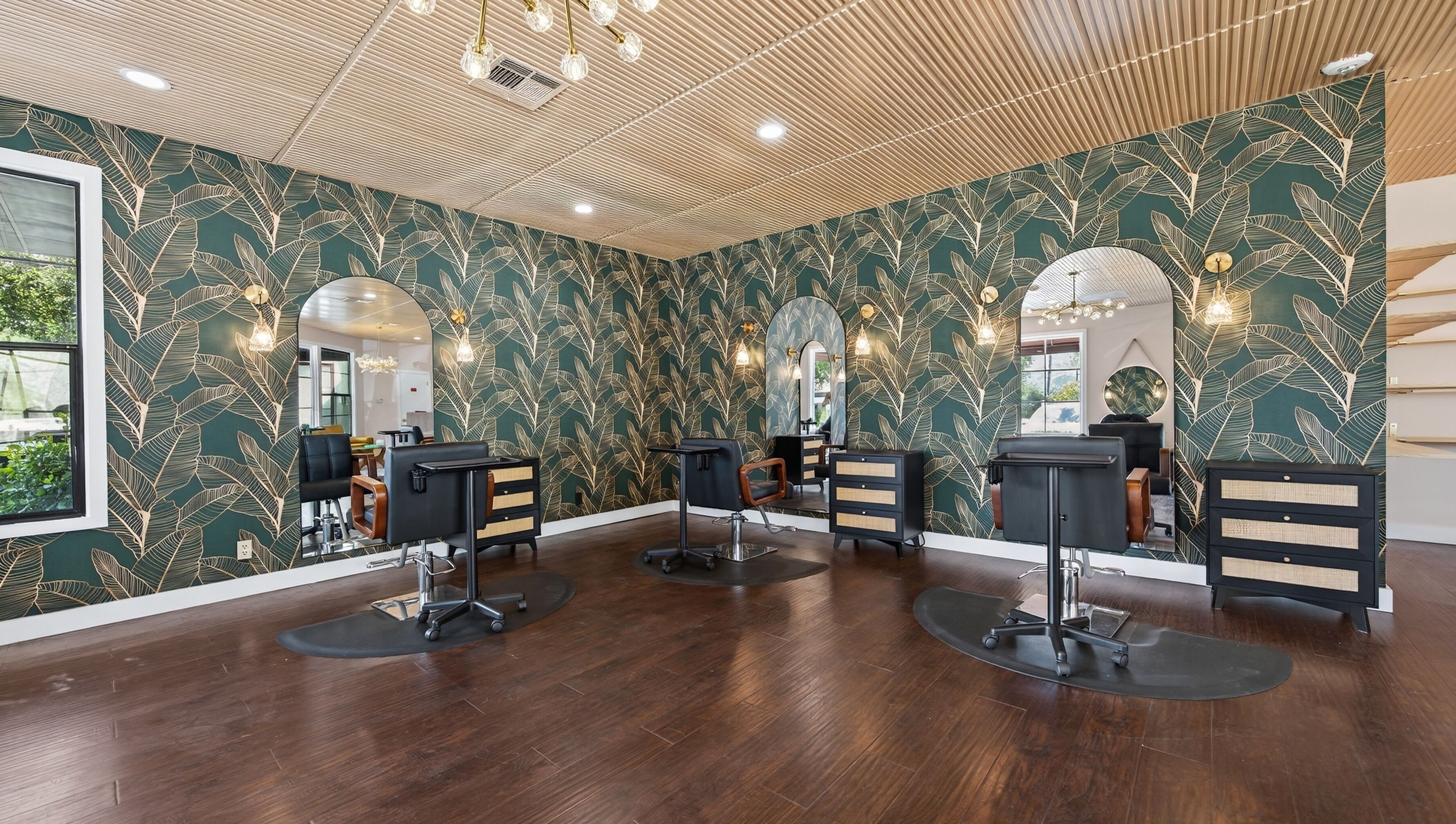 Chic salon interior at Bijou, Ojai, California, US, featuring botanical wallpaper and modern beauty stations.