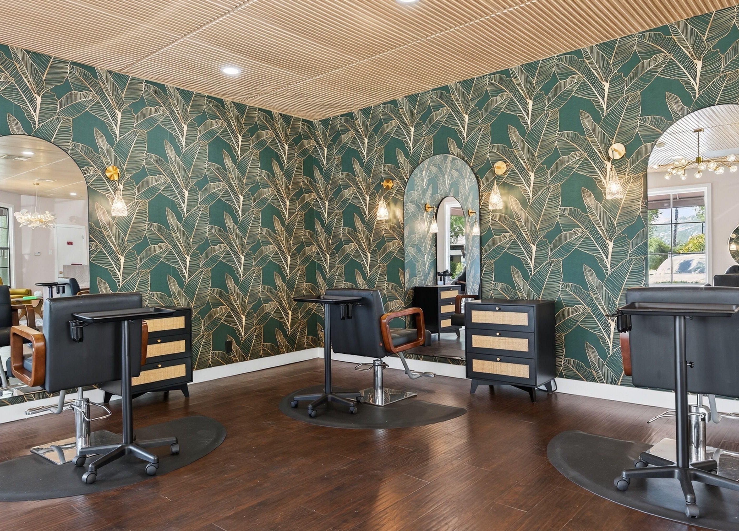 Chic salon interior at Bijou, Ojai, California, US, featuring stylish wallpaper and modern salon chairs.