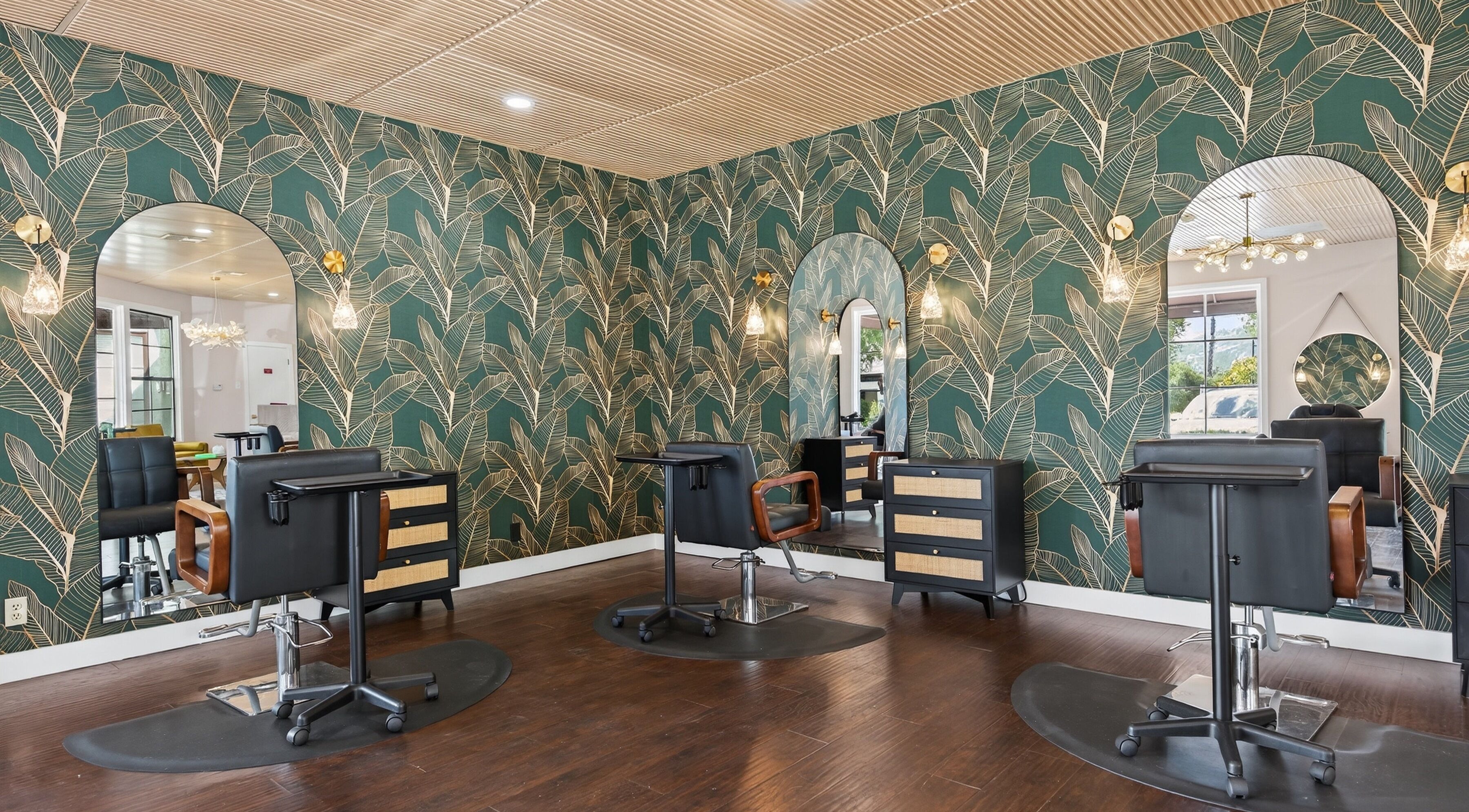 Chic salon interior at Bijou, Ojai, California, US, featuring stylish wallpaper and modern salon chairs.