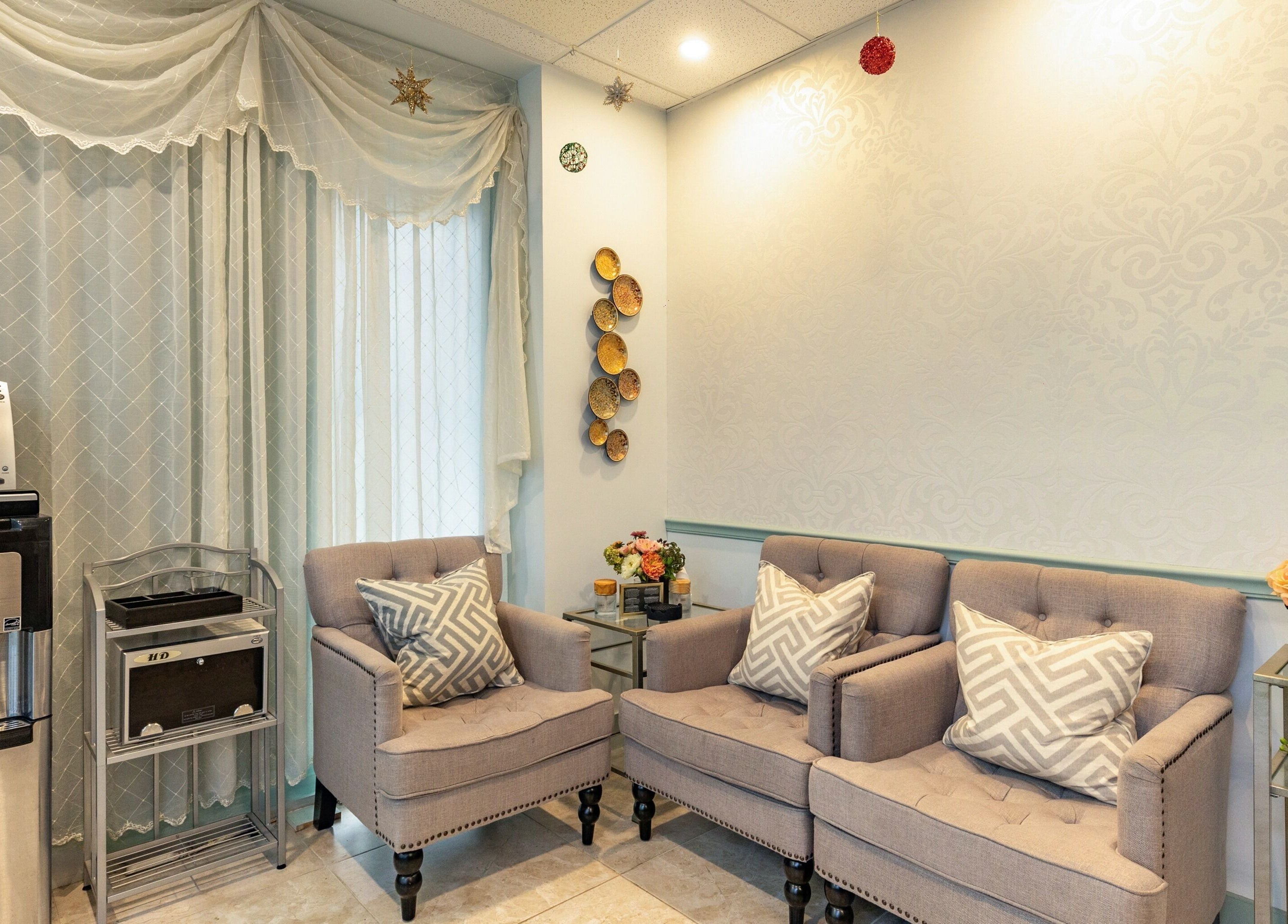 Cozy waiting area at Cilium Lash Studio, New York, New York, US with plush chairs and elegant decor.