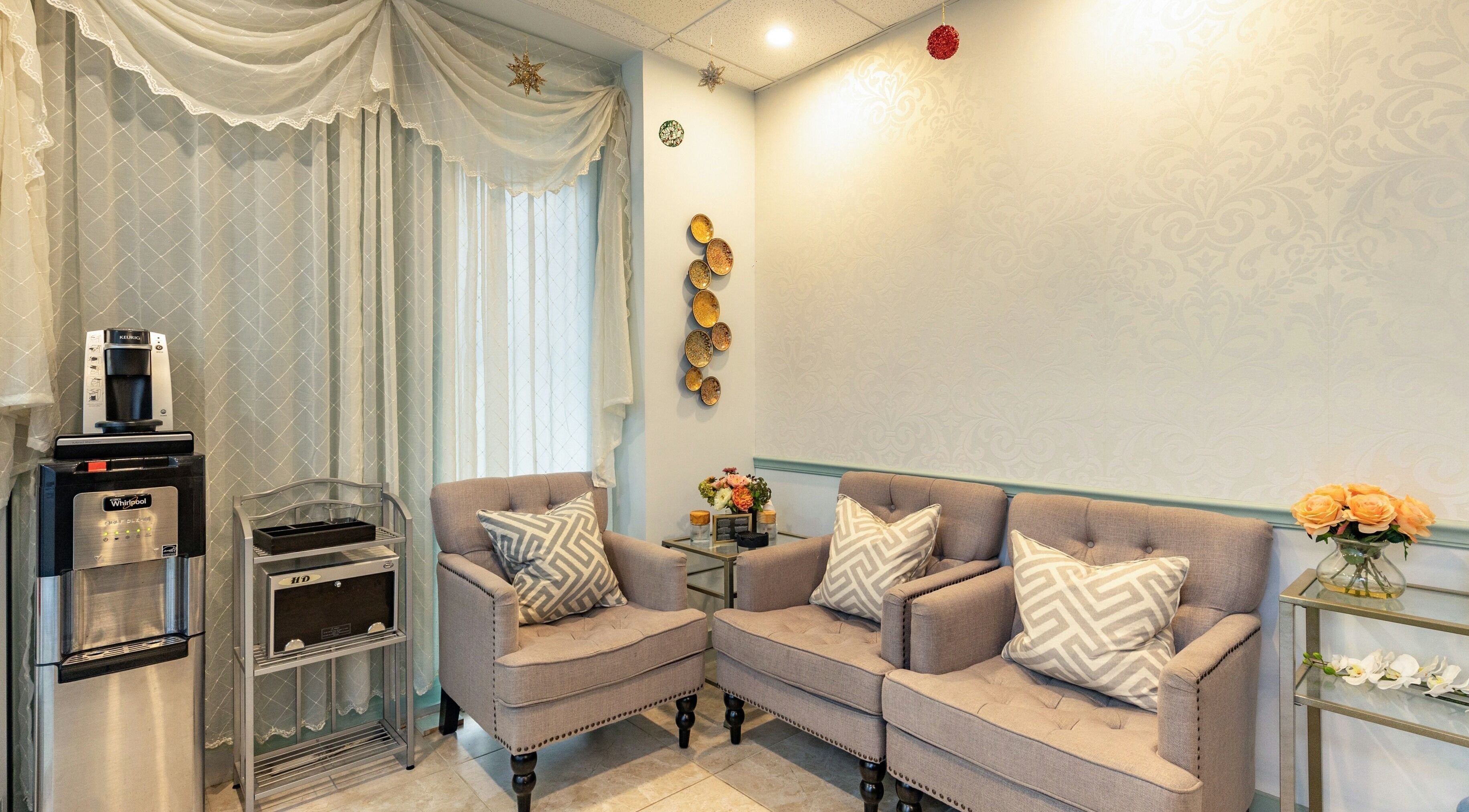 Cozy waiting area at Cilium Lash Studio, New York, New York, US with plush chairs and elegant decor.