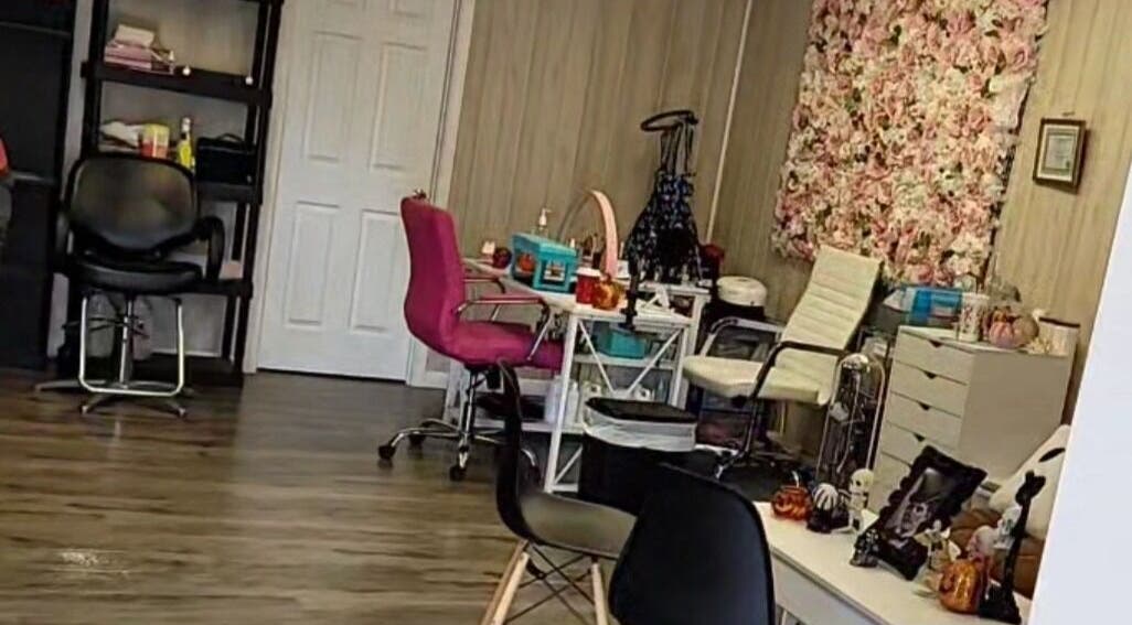 Elegant interior of Doll Houz Nail Suite in Conway, Arkansas with floral decor and comfy seating.