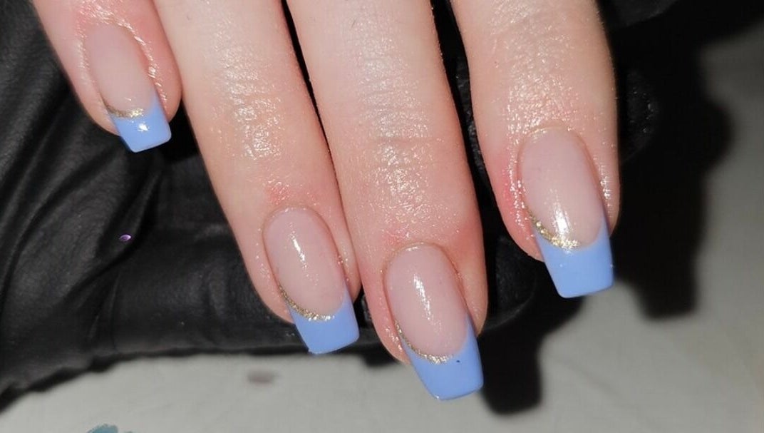 Elegant blue French manicure at Alchemy Beauty, Southport, England, GB. Elevated nail art design with gold accents.