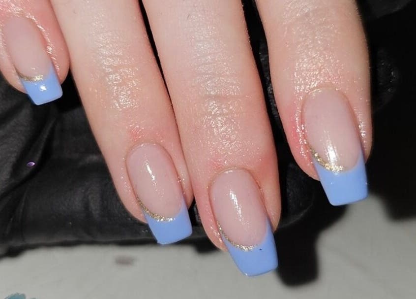 Elegant blue French manicure at Alchemy Beauty, Southport, England, GB. Elevated nail art design with gold accents.