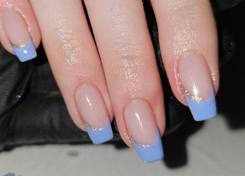 Elegant blue French manicure at Alchemy Beauty, Southport, England, GB. Elevated nail art design with gold accents.