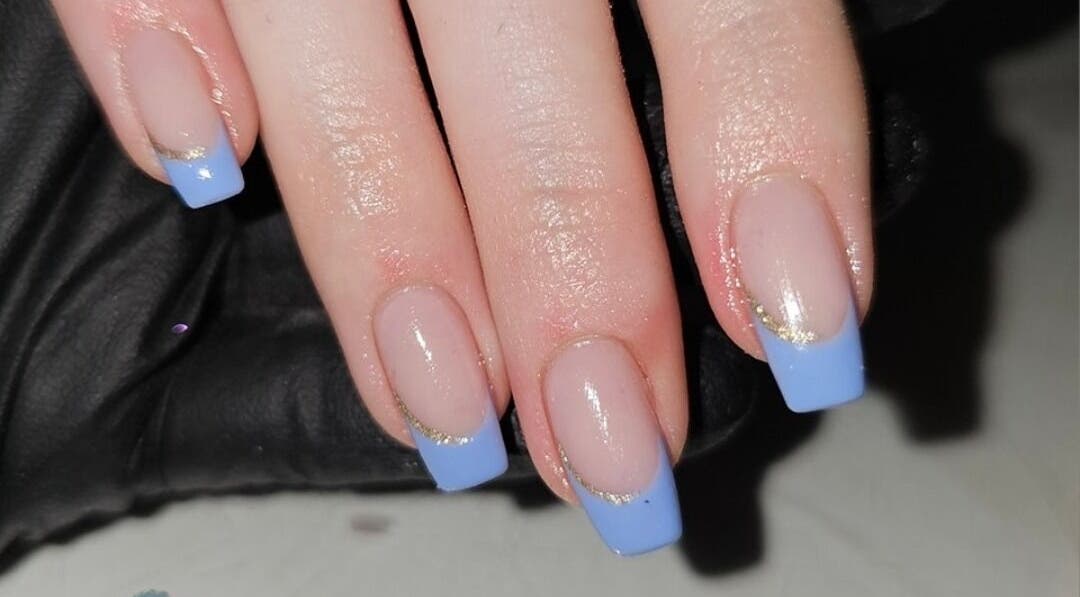 Elegant blue French manicure at Alchemy Beauty, Southport, England, GB. Elevated nail art design with gold accents.
