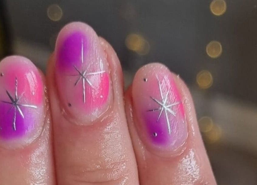 Vibrant galaxy-inspired nails at Alchemy Beauty in Southport, England, GB with starburst design.