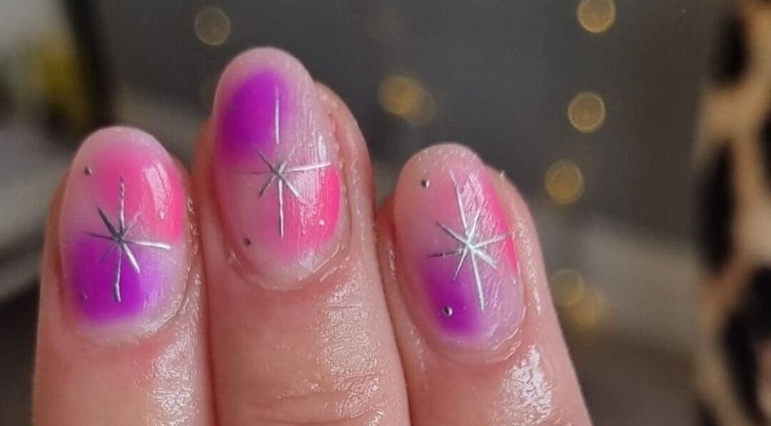 Vibrant galaxy-inspired nails at Alchemy Beauty in Southport, England, GB with starburst design.