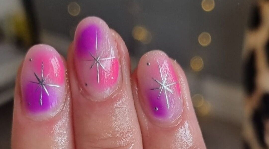Vibrant galaxy-inspired nails at Alchemy Beauty in Southport, England, GB with starburst design.