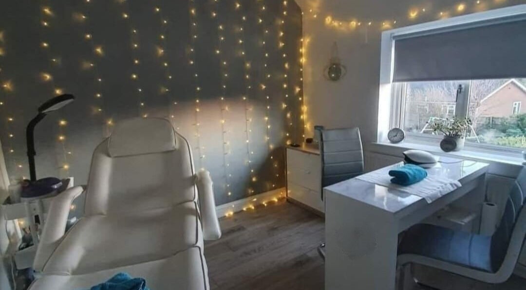 Tranquil treatment room at Alchemy Beauty, Southport, England, GB with cozy lighting and modern decor.