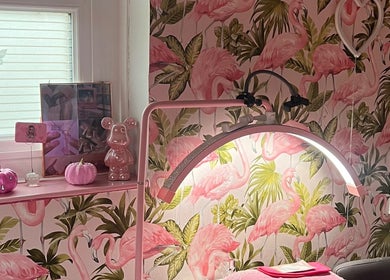 Stylish beauty space at Lashes By Leesh Witney, decorated with flamingo wallpaper in Witney, England, GB.
