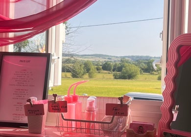 A scenic view from inside 'Lashes by Leesh Bledington', Chipping Norton, England, GB, showcasing pricing and beauty supplies.