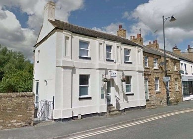 Street view of El Beauty Training Academy in Market Deeping, England, showcasing the charming white facade.