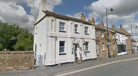 Street view of El Beauty Training Academy in Market Deeping, England, showcasing the charming white facade.