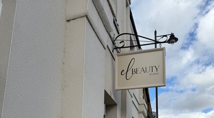 Exterior sign of El Beauty Studio in Market Deeping, England, GB, against a cloudy sky.