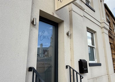 Exterior view of El Beauty Studio entrance in Market Deeping, England, GB, featuring sleek signage.