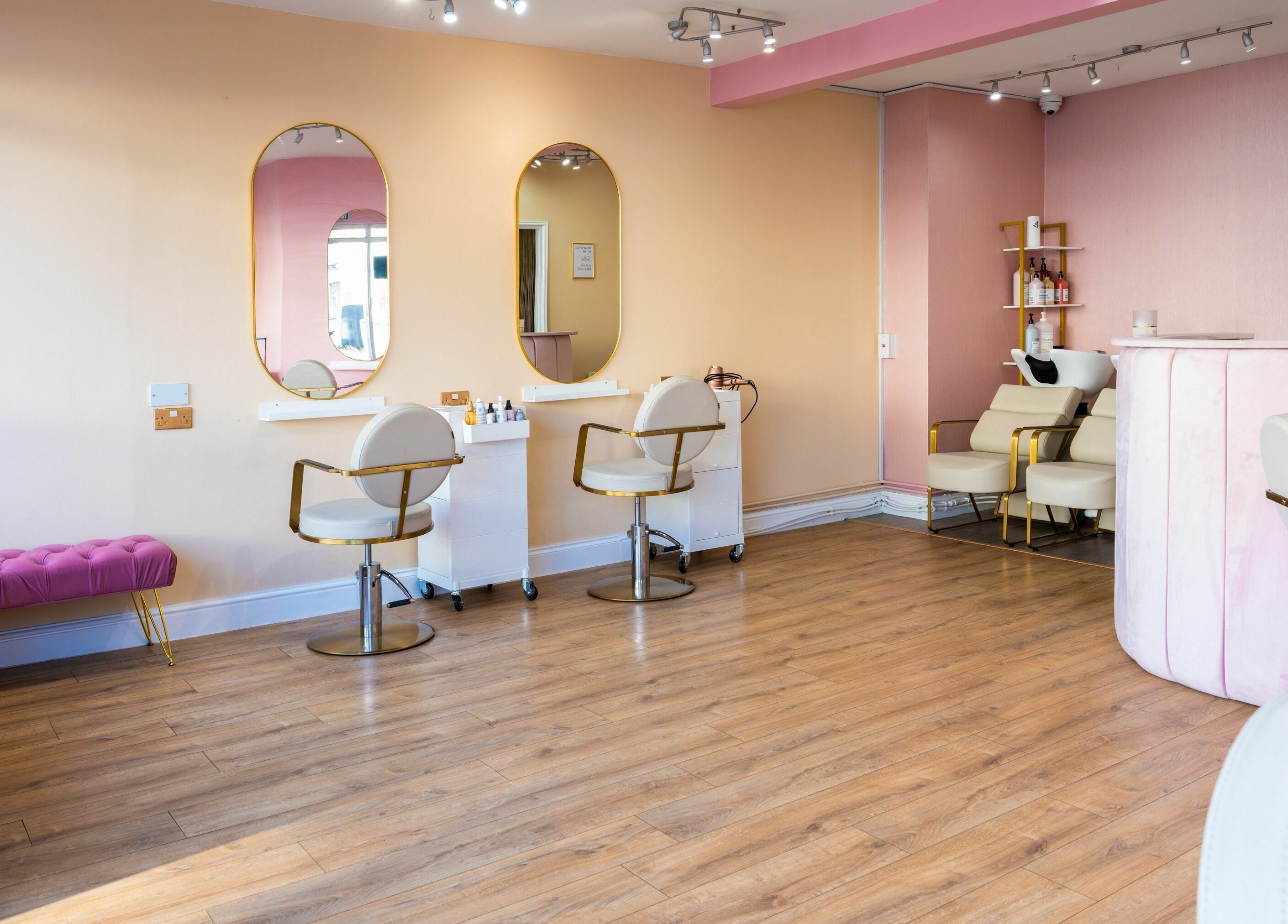 Head Start salon in Swanscombe, England, GB features elegant decor with pastel pink accents and stylish seating.