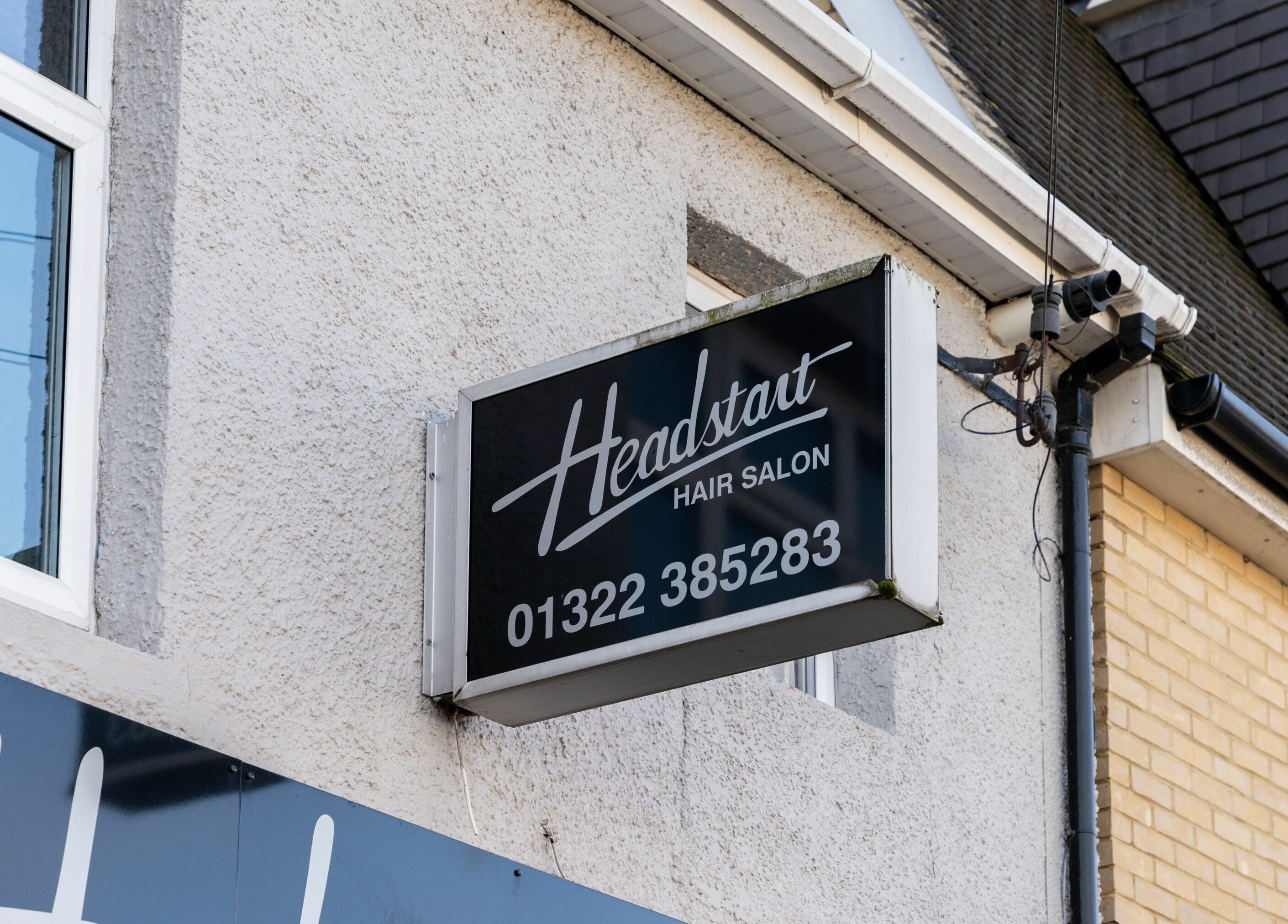 Head Start hair salon sign at Swanscombe, England, GB. Prominent outdoor signage for visibility.