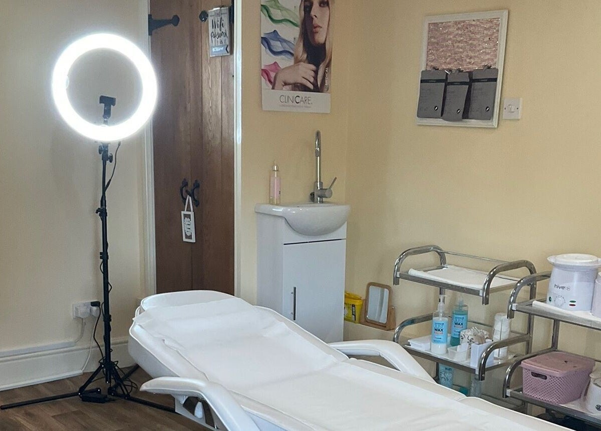 Cozy treatment room at La Bonne Vie, Cawood, England, GB with a comfortable bed and beauty equipment.