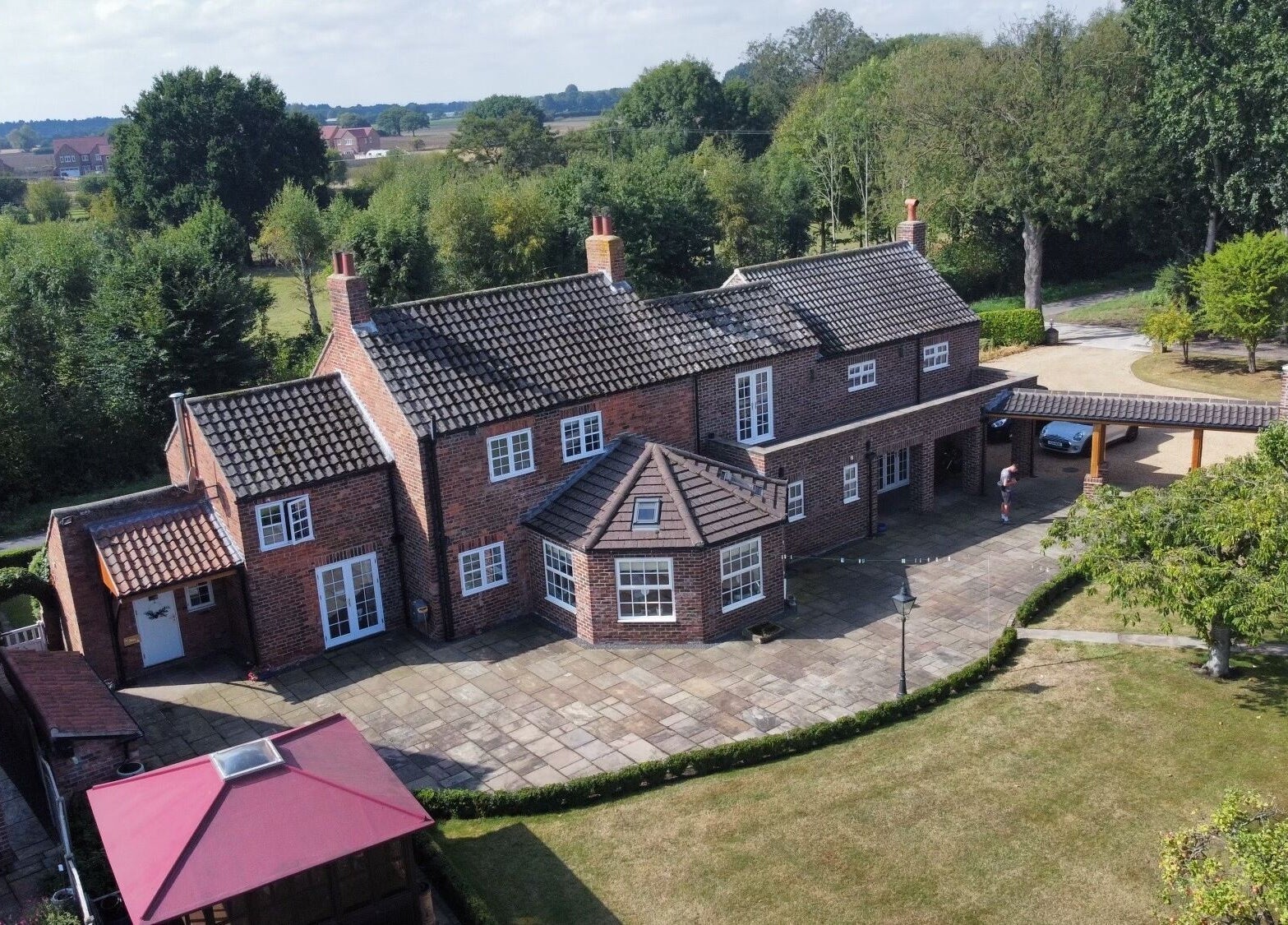 Aerial view of La Bonne Vie in Cawood, England, GB surrounded by lush greenery and a spacious courtyard.