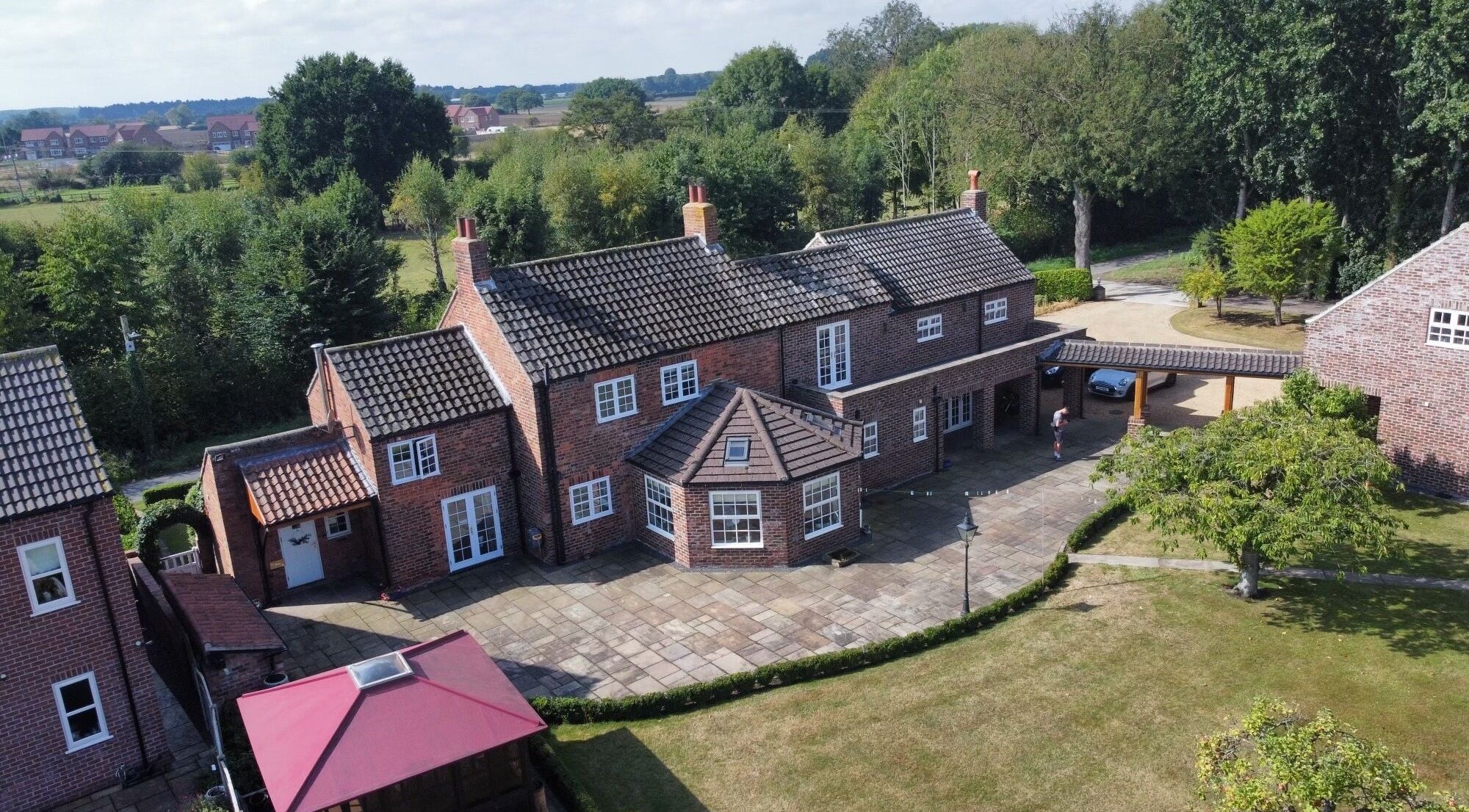Aerial view of La Bonne Vie in Cawood, England, GB surrounded by lush greenery and a spacious courtyard.