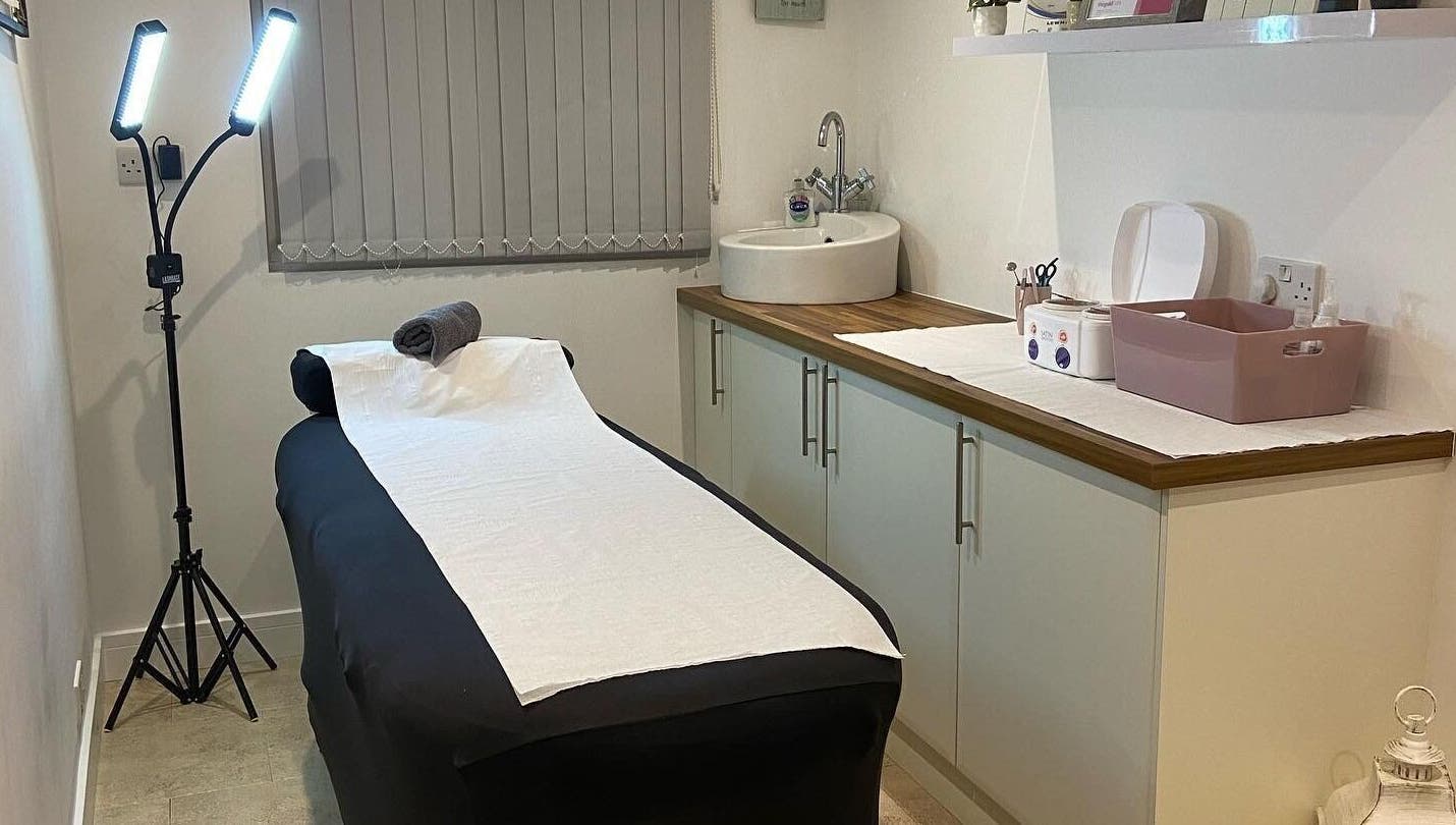 Cozy treatment room at Debeaut by Della in Havant, England, GB, featuring a massage table and calming decor.